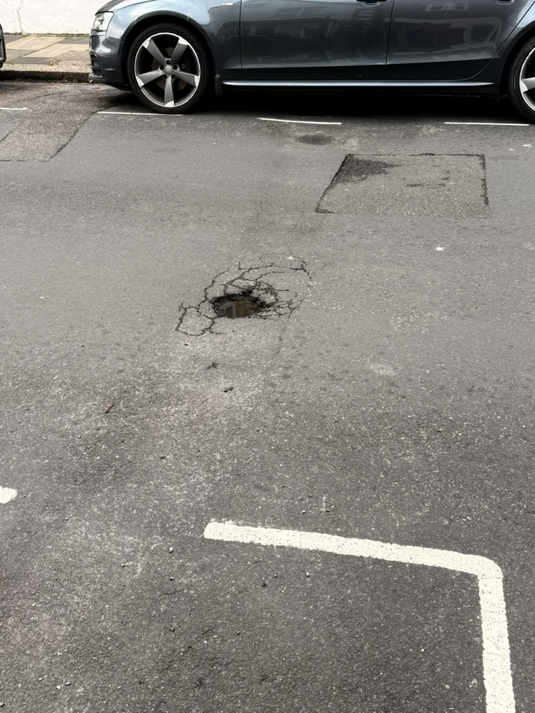 Example of road maintenance needs in Westbourne - Pothole requiring repair on local street